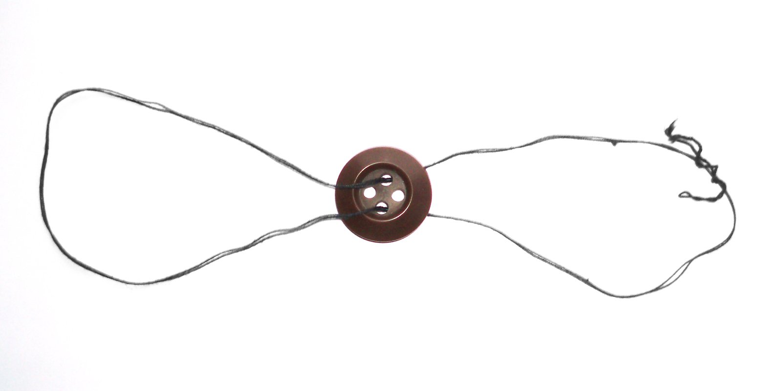 A traditional button whirligig from Ukraine—called a furkalka