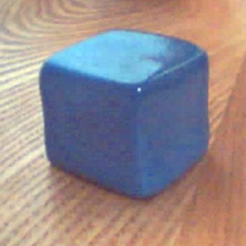 Silly Putty in the form of a solid cube
