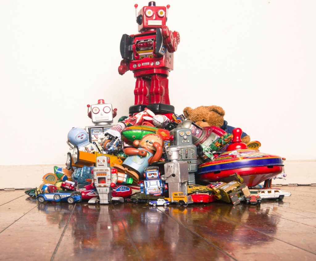 a pile of robots and other vintage toys