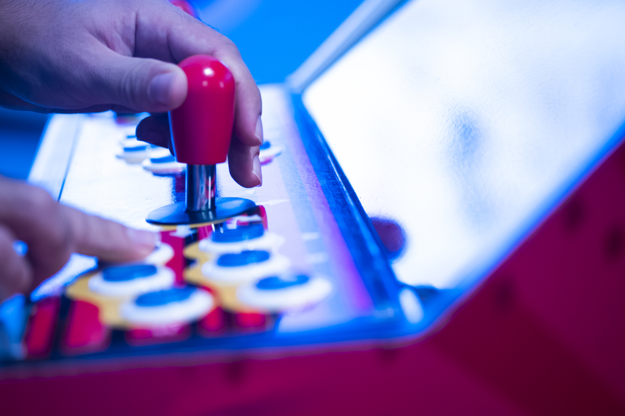Close up shot of person playing with a arcade machine